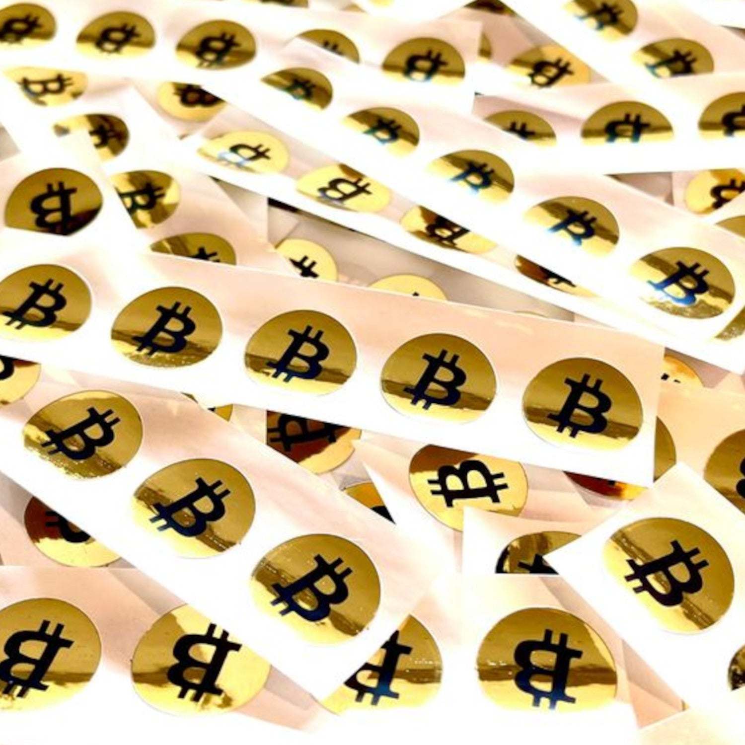 Set of 10 small gold Bitcoin stickers with glossy foil on black paper